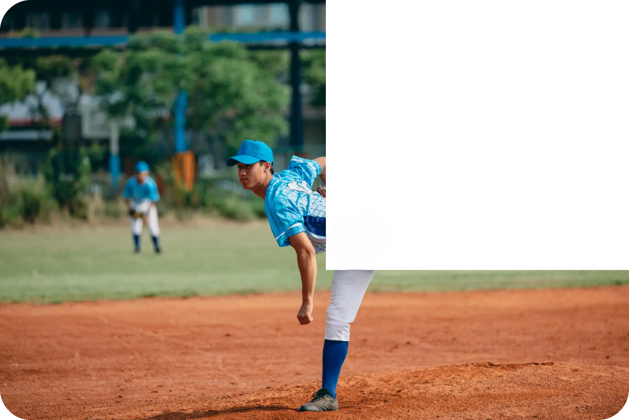 Baseball pitcher in blue uniform on mound